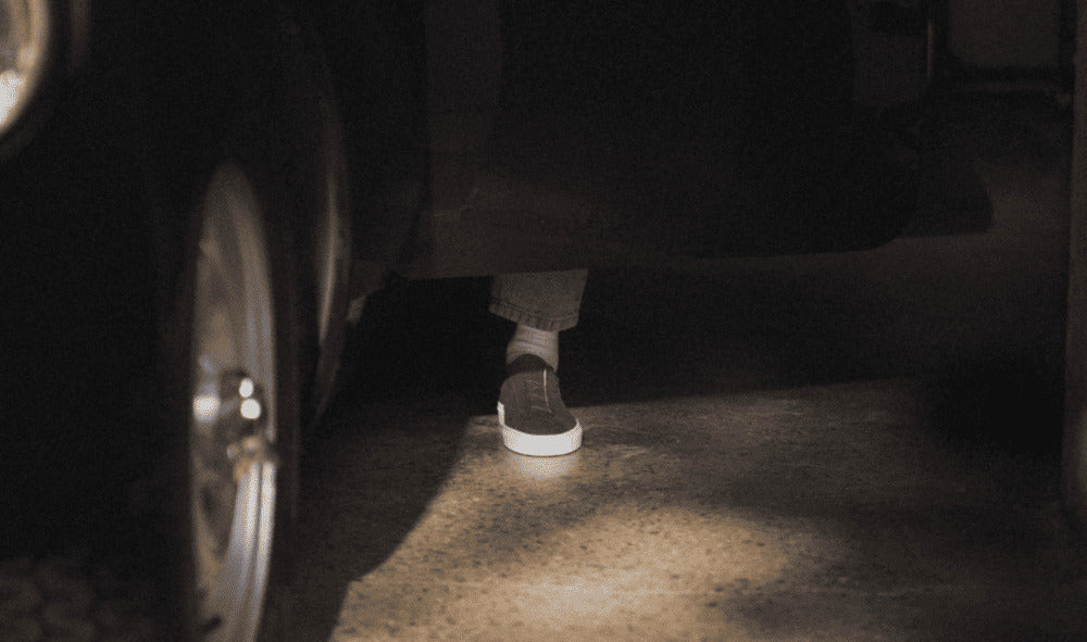 Person wearing the Capri nubuck low-top sneaker beside a car in low light