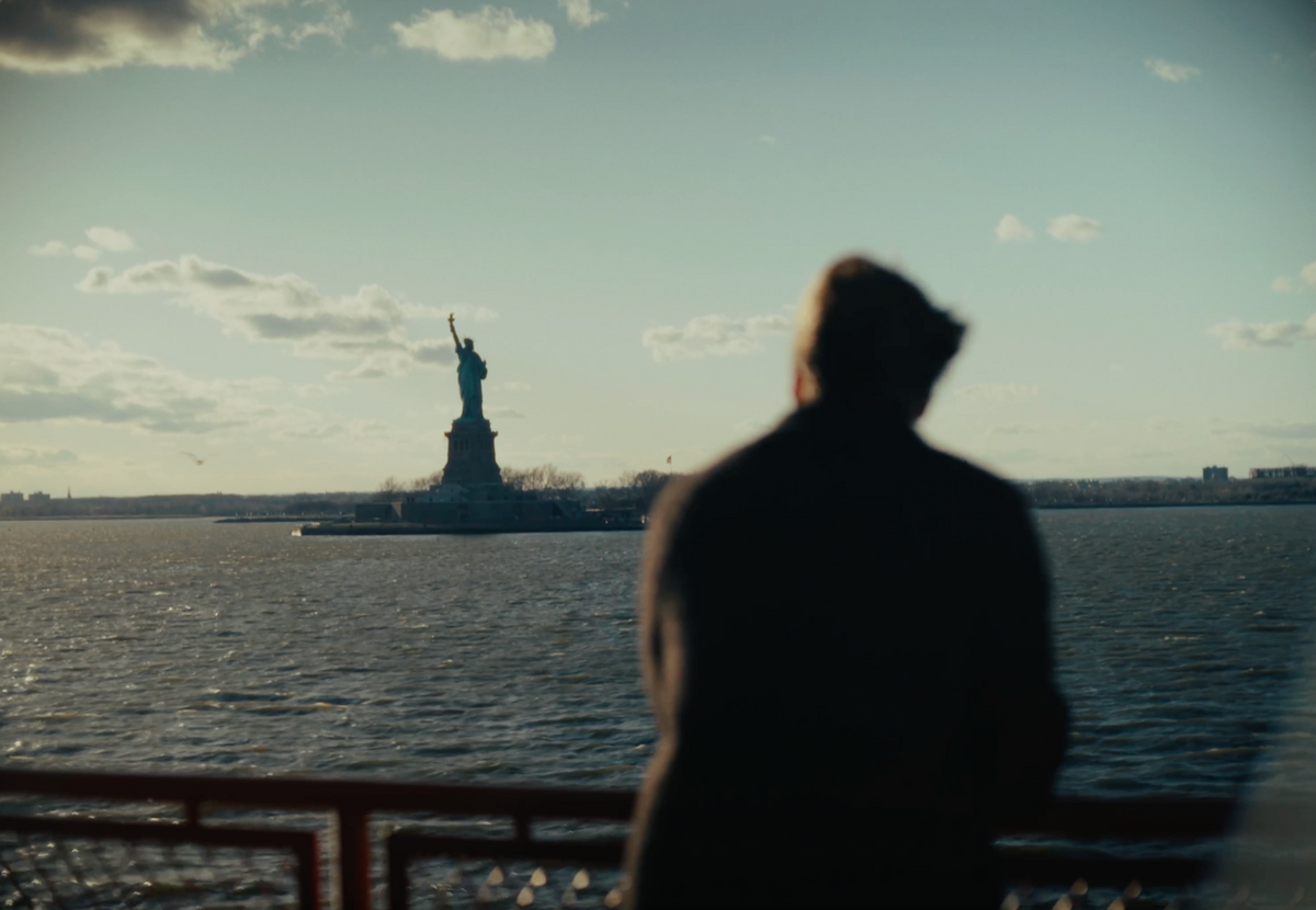 Person viewing the Statue of Liberty from a ferry on New York Harbor