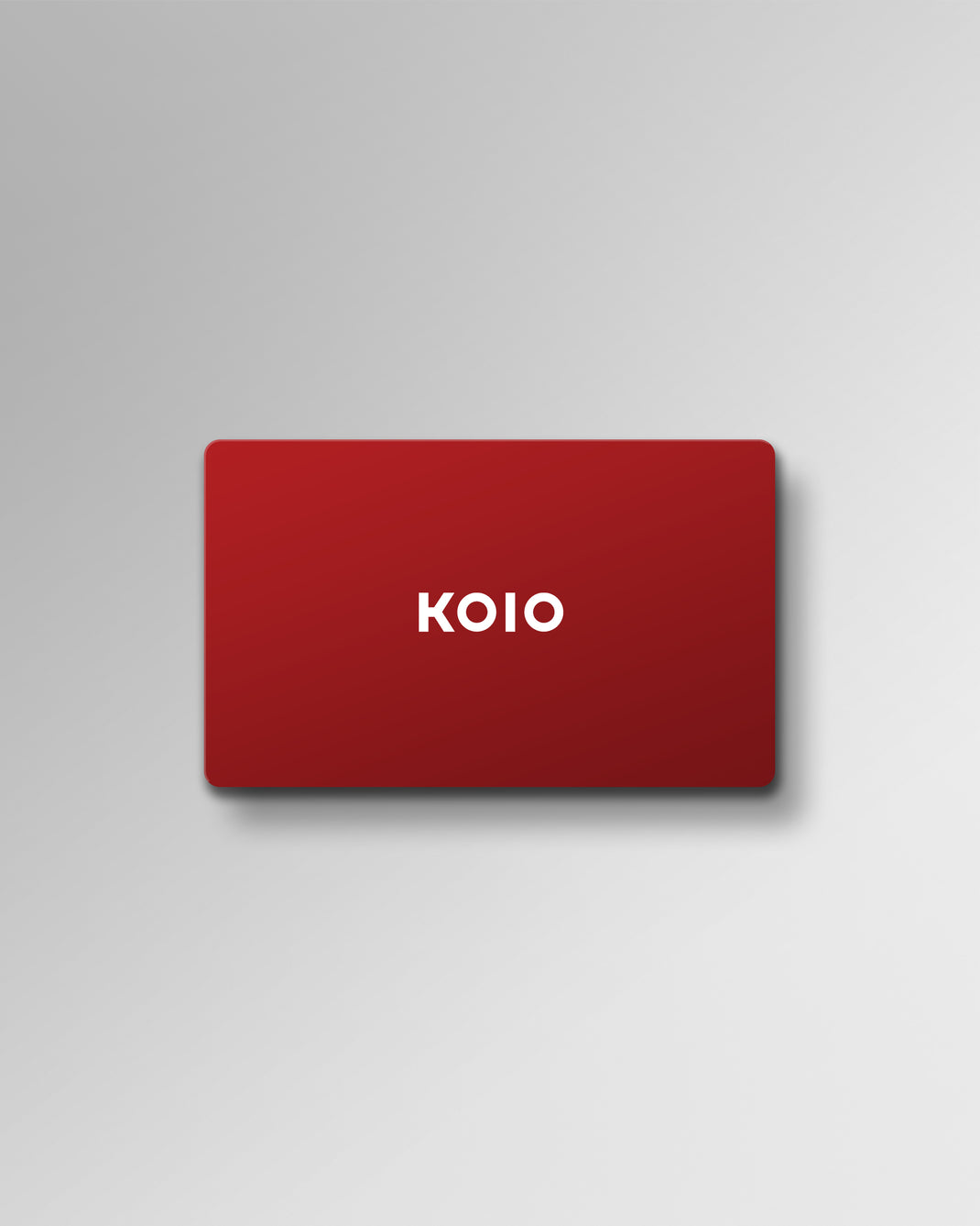 Front view of a red KOIO gift card showcasing the white KOIO logo on a light gray background