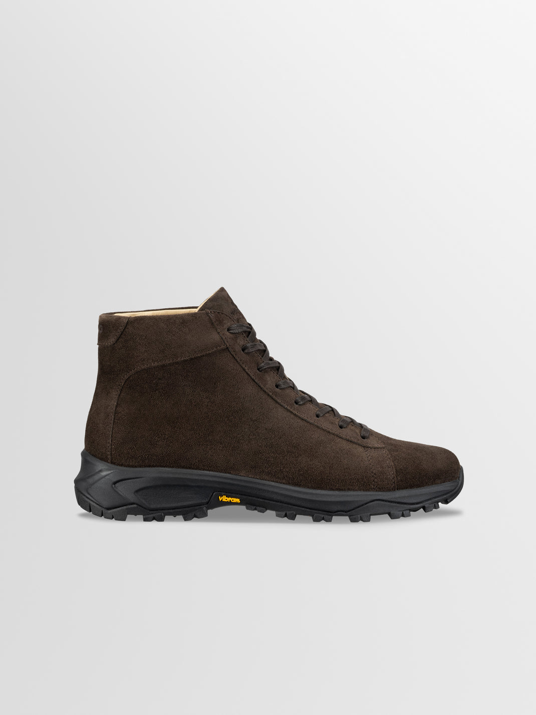 Side view of Aosta in Cacao boots showcasing brown suede, lace-up styling, and black Vibram lug sole on a light gray background