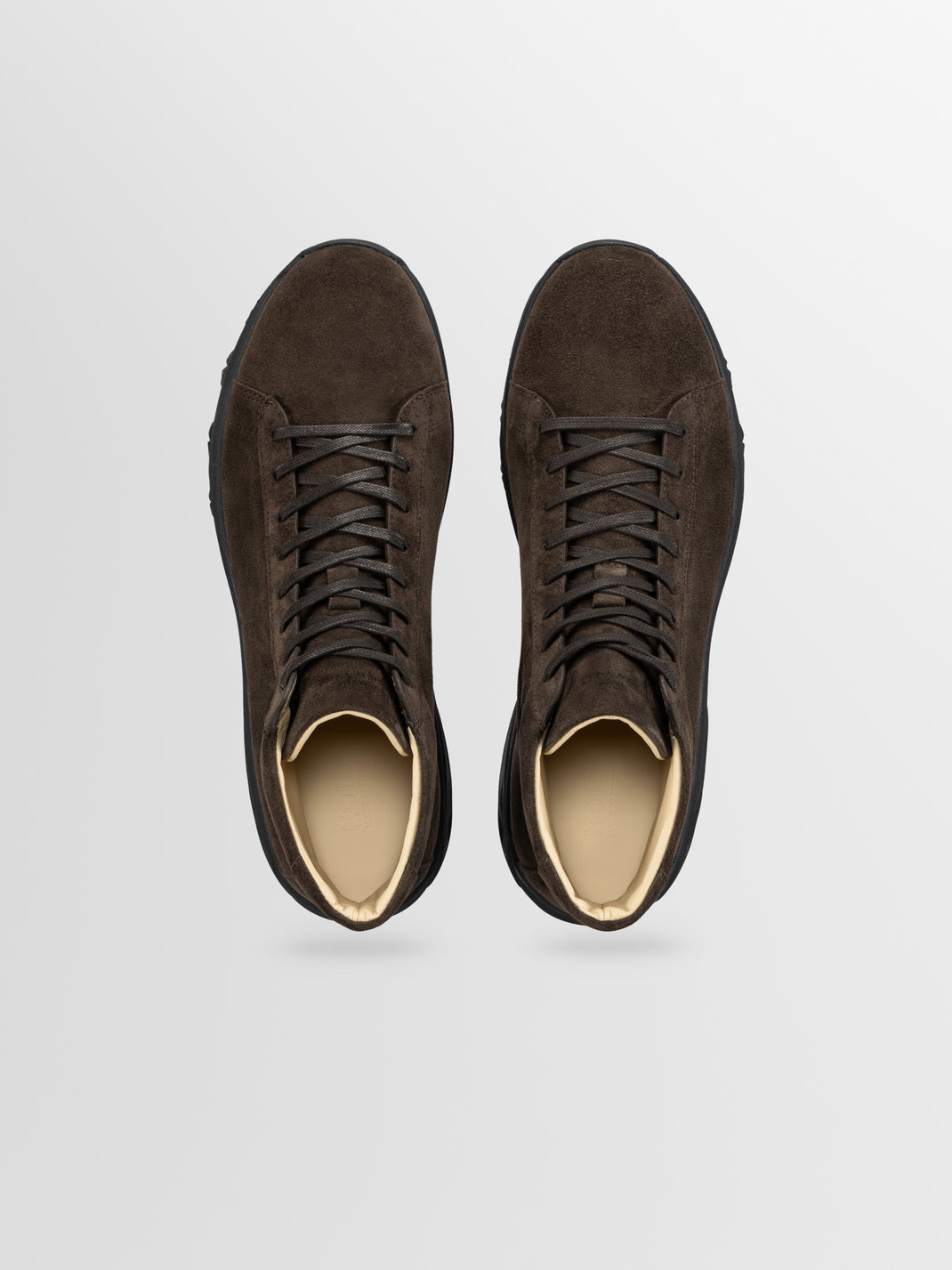 Top view of Aosta in Cacao men’s brown suede boots showcasing lace-up design on a light gray background