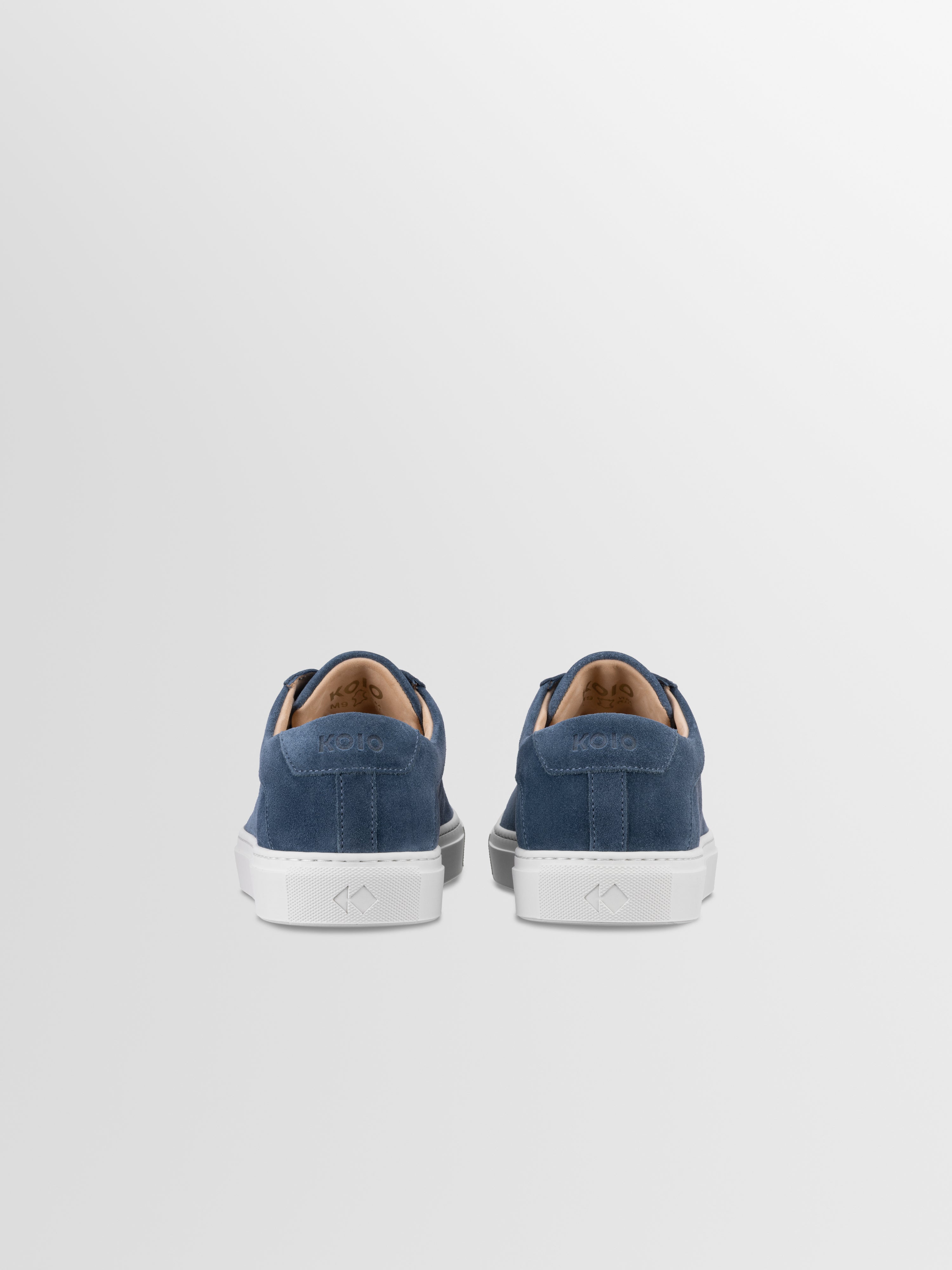 Blue suede sneakers with matching laces and white rubber soles