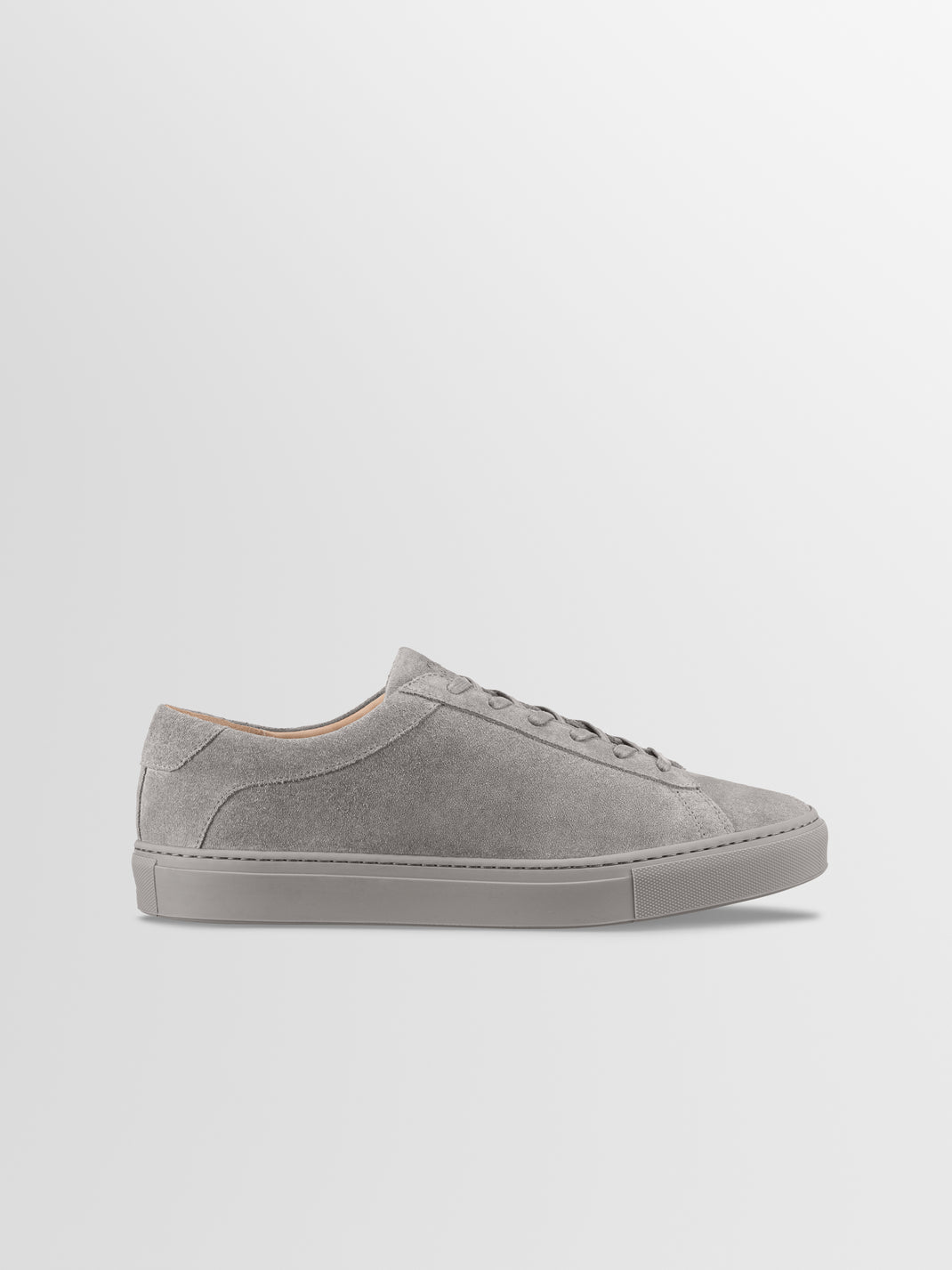 Side view of men’s Capri low-top sneaker in mineral suede showcasing a tonal rubber sole against a light gray background