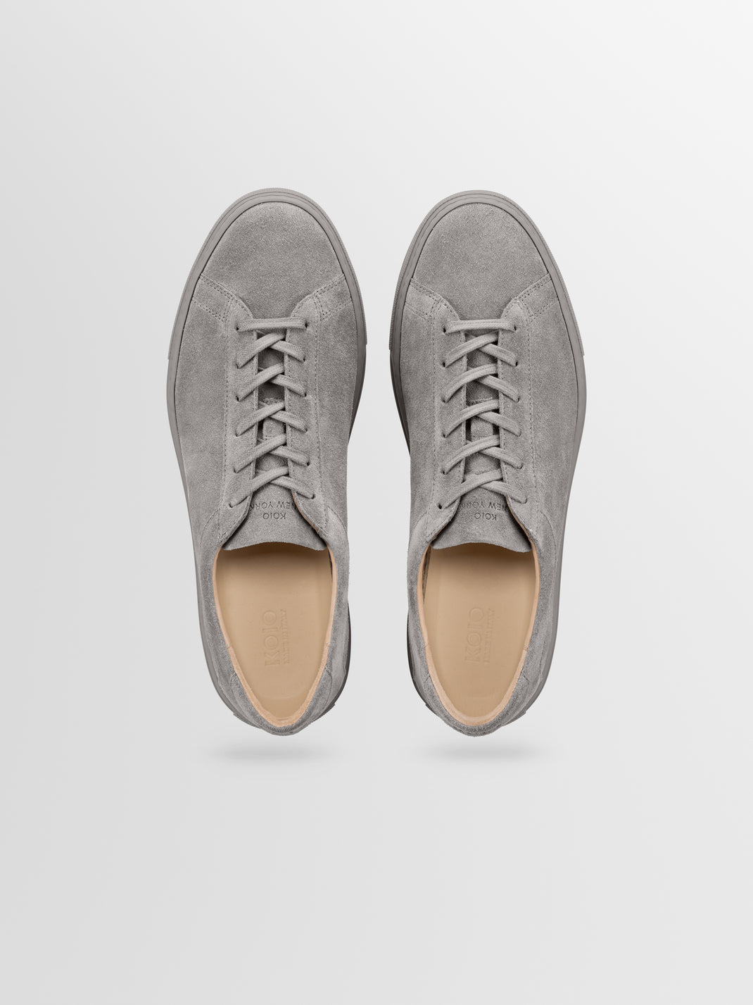 Top view of mens Capri low-top sneakers in Mineral suede showcasing tonal laces on a light gray background