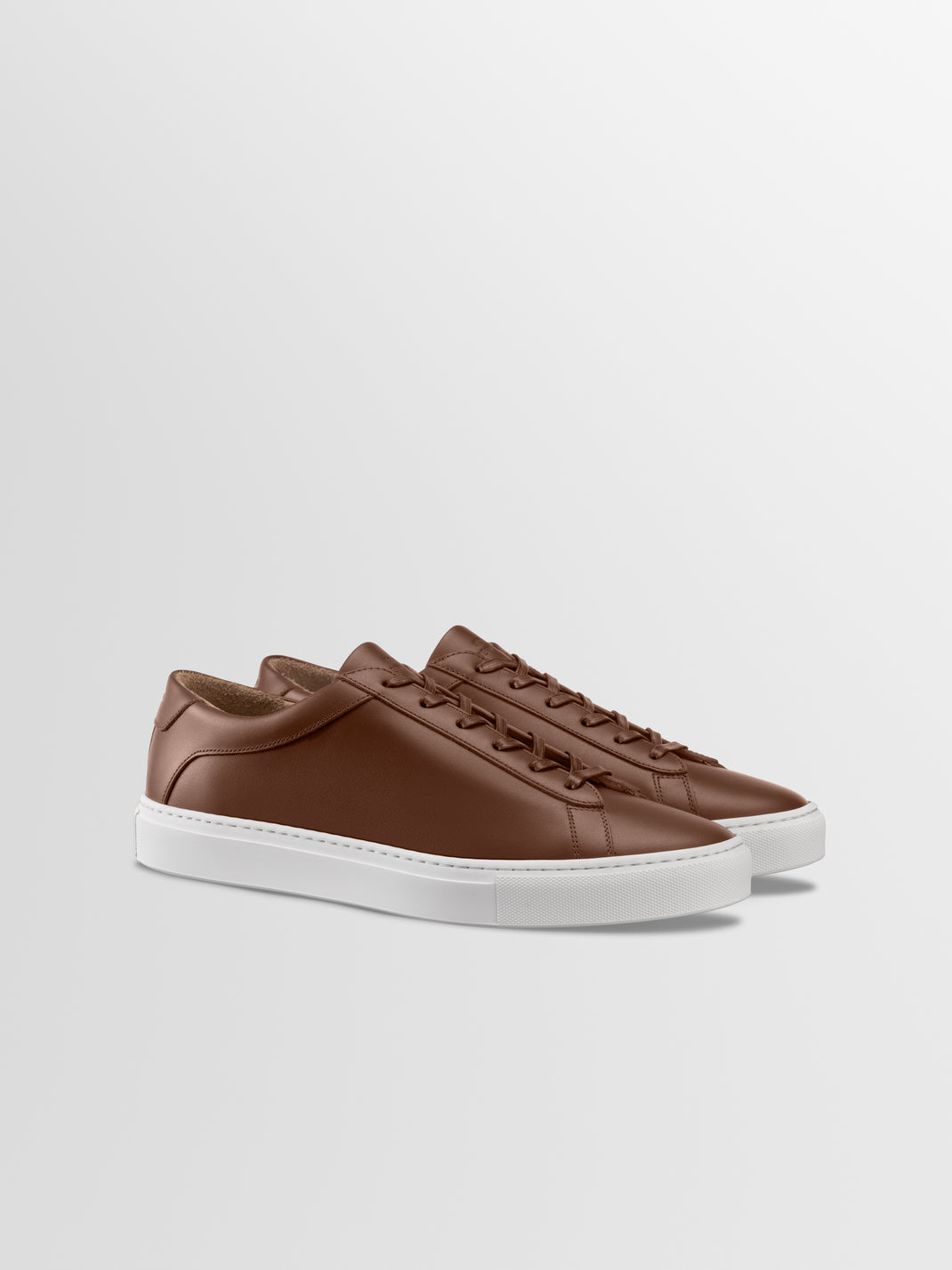 Brown leather sneakers with matching laces and white rubber soles