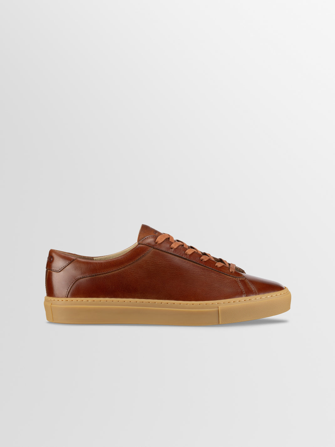 Side view of Capri in Antica Castagna men’s brown leather low-top sneaker showcasing tonal laces and gum rubber sole on a light gray background