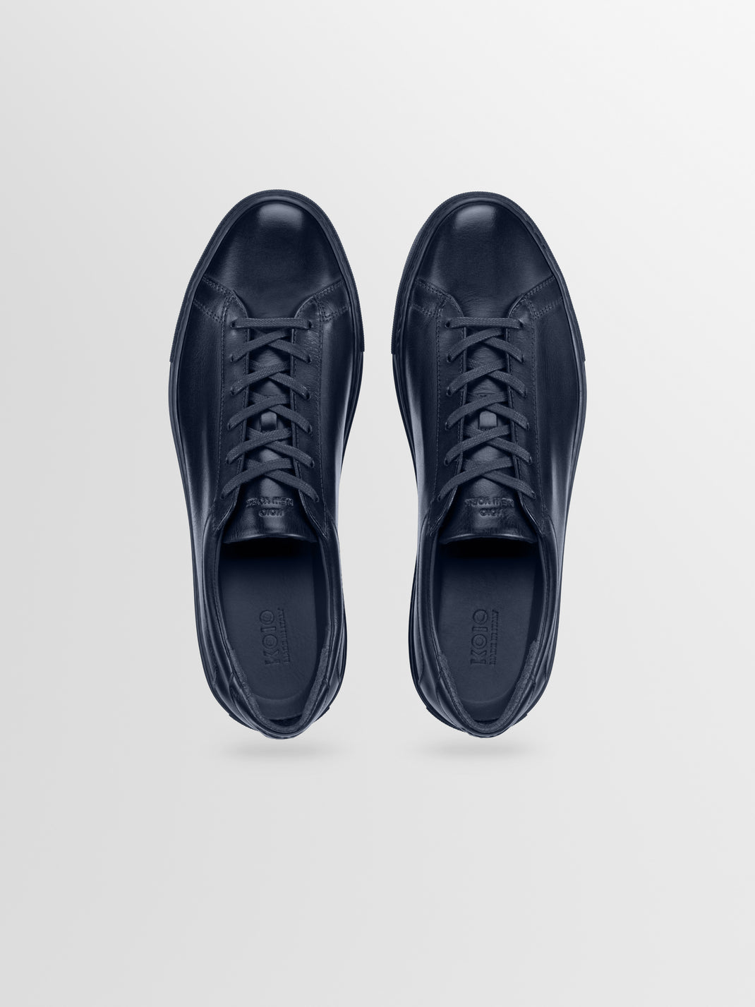 Top view of Capri in Antica Space low-top sneakers showcasing navy leather uppers and laces on a light gray background