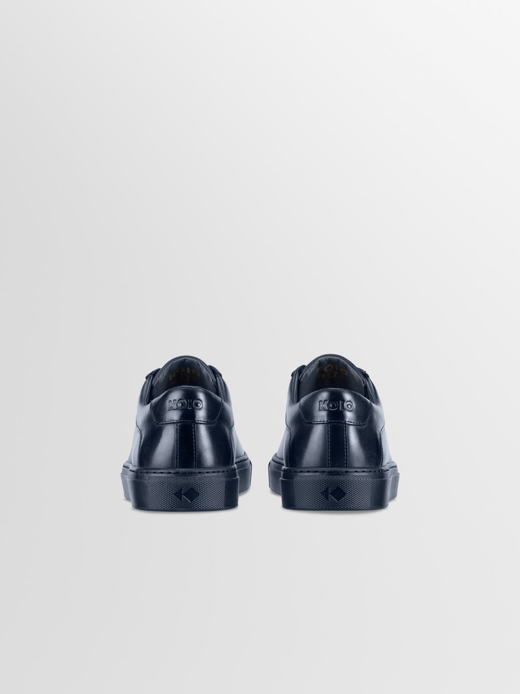 Rear view of Capri in Antica Space low-top sneakers showcasing navy leather uppers with a light gray background