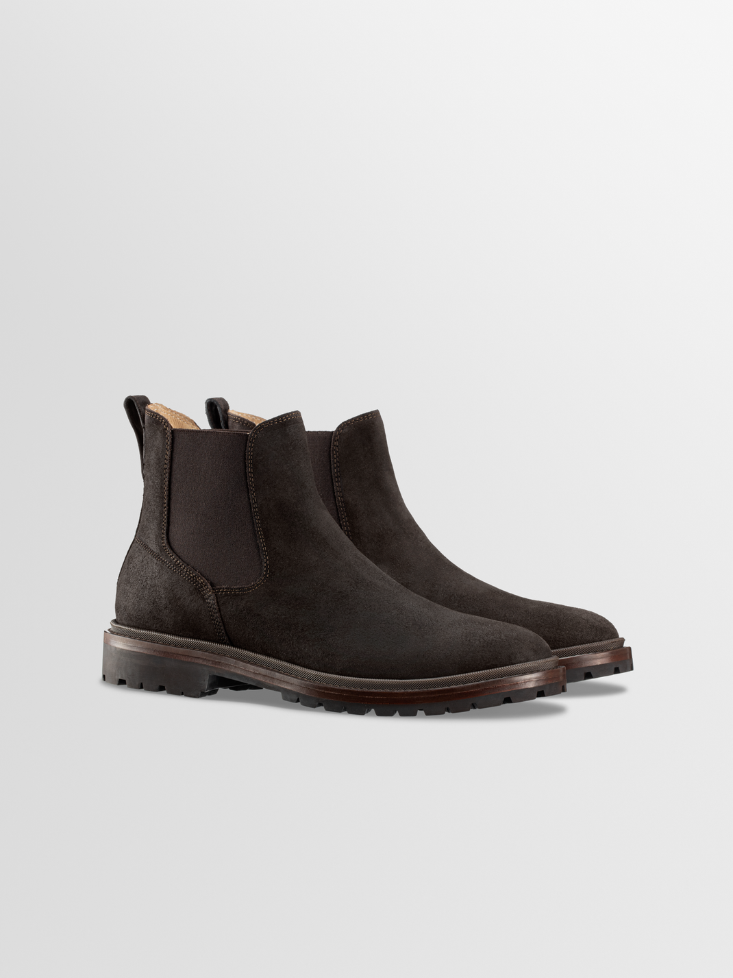 Front three-quarter view of Fermo suede Chelsea boots in Pinecone showcasing elastic side panels and lug soles with a light gray background