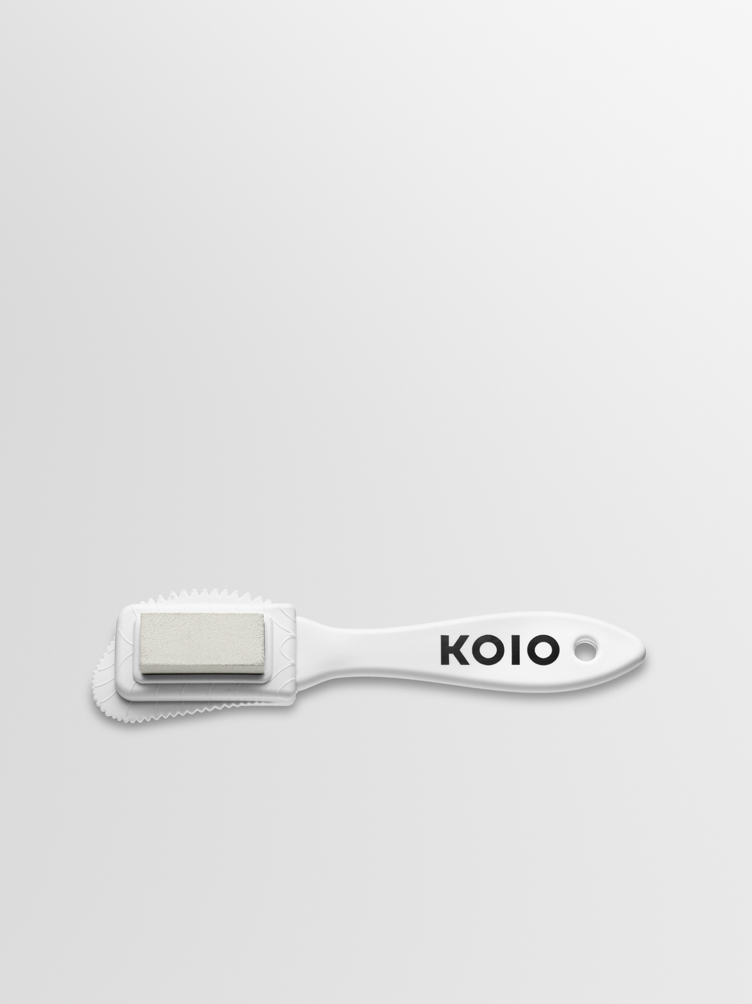 Side view of Koio Suede Brush showcasing its cleaning head and KOIO branded handle on a white background