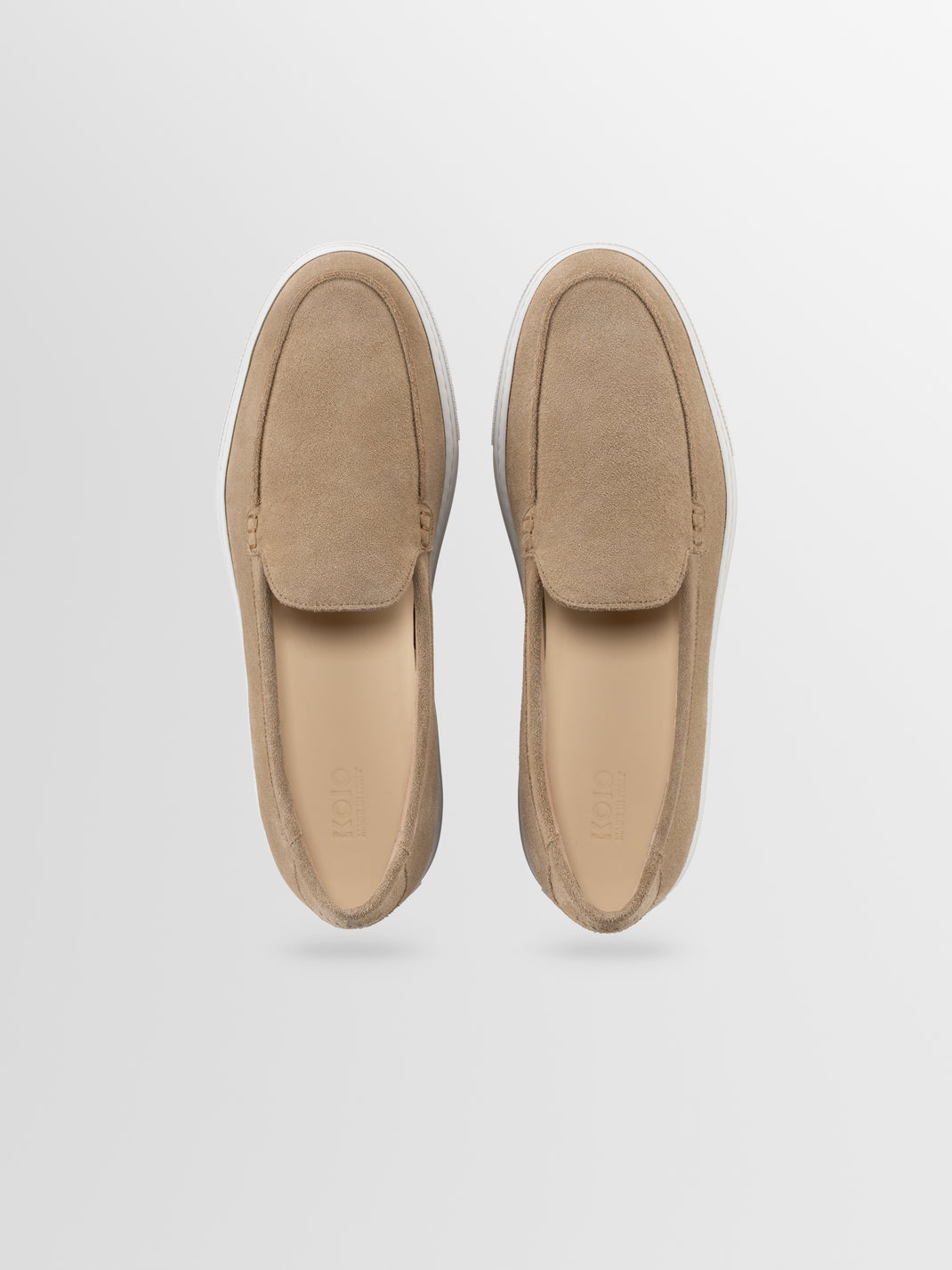 Top view of Lido men’s beige suede slip-on loafers showcasing stitched moc toes with a light gray background