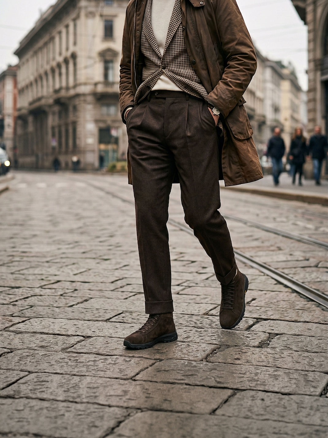 Worn view of Aosta in Cacao brown suede boots showcasing lace-up uppers on a cobblestone city street