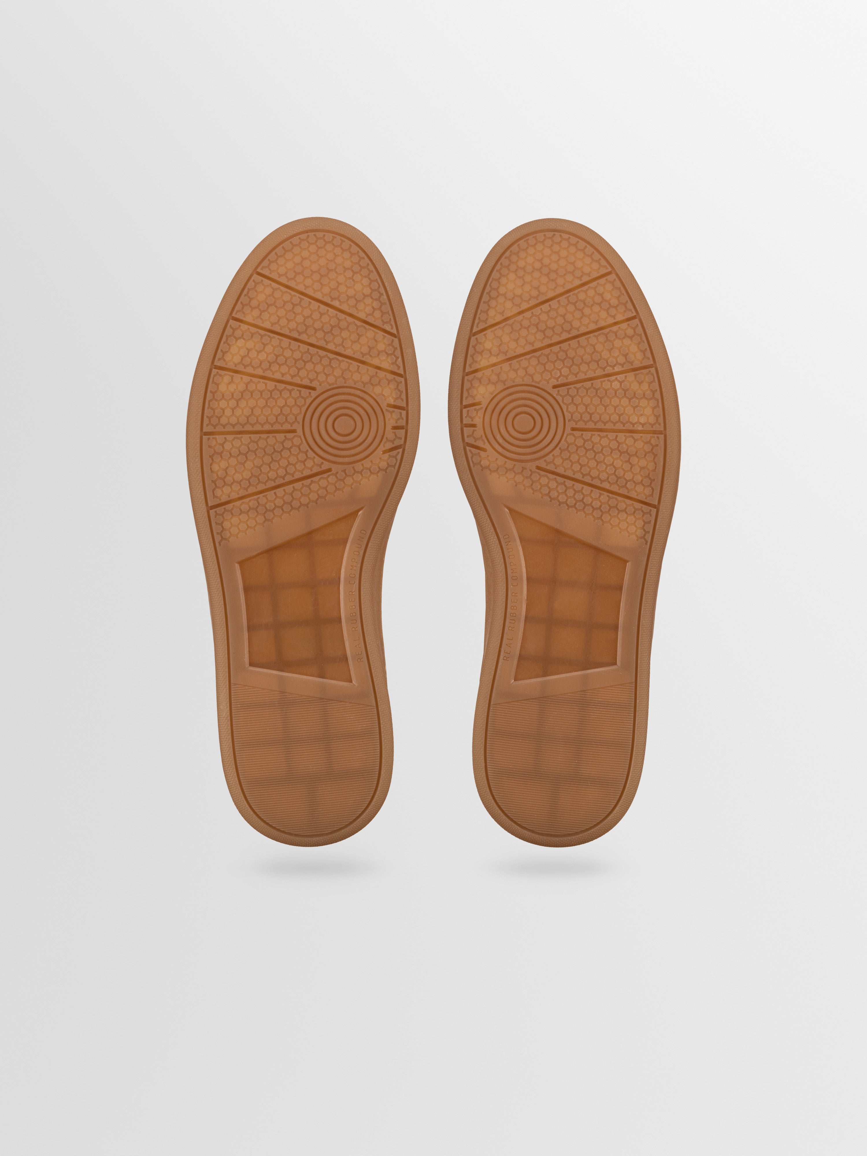 A pair of brown rubber shoe soles from men