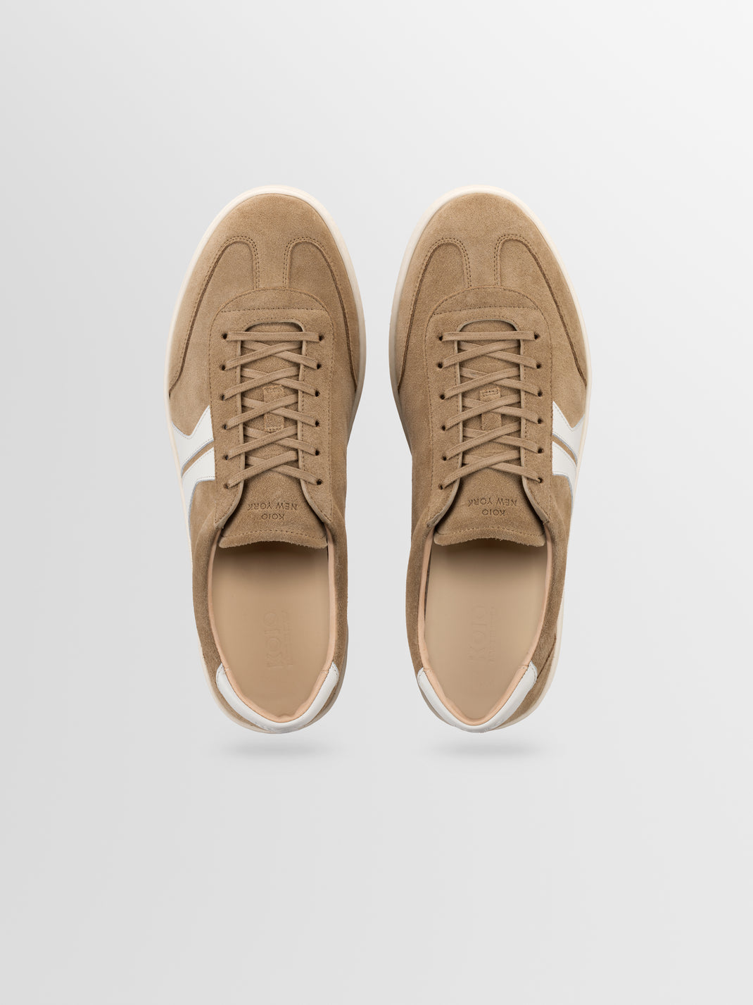 Top view of Monza in Wheat low-top sneakers showcasing suede uppers, laces, and white side stripes on a light gray background