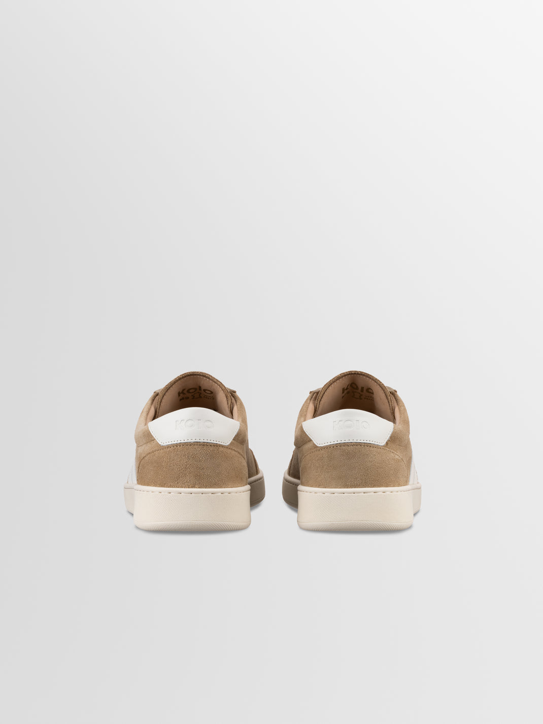 Rear view of Monza in Wheat low top sneakers showcasing suede uppers and white rubber soles on a light gray background