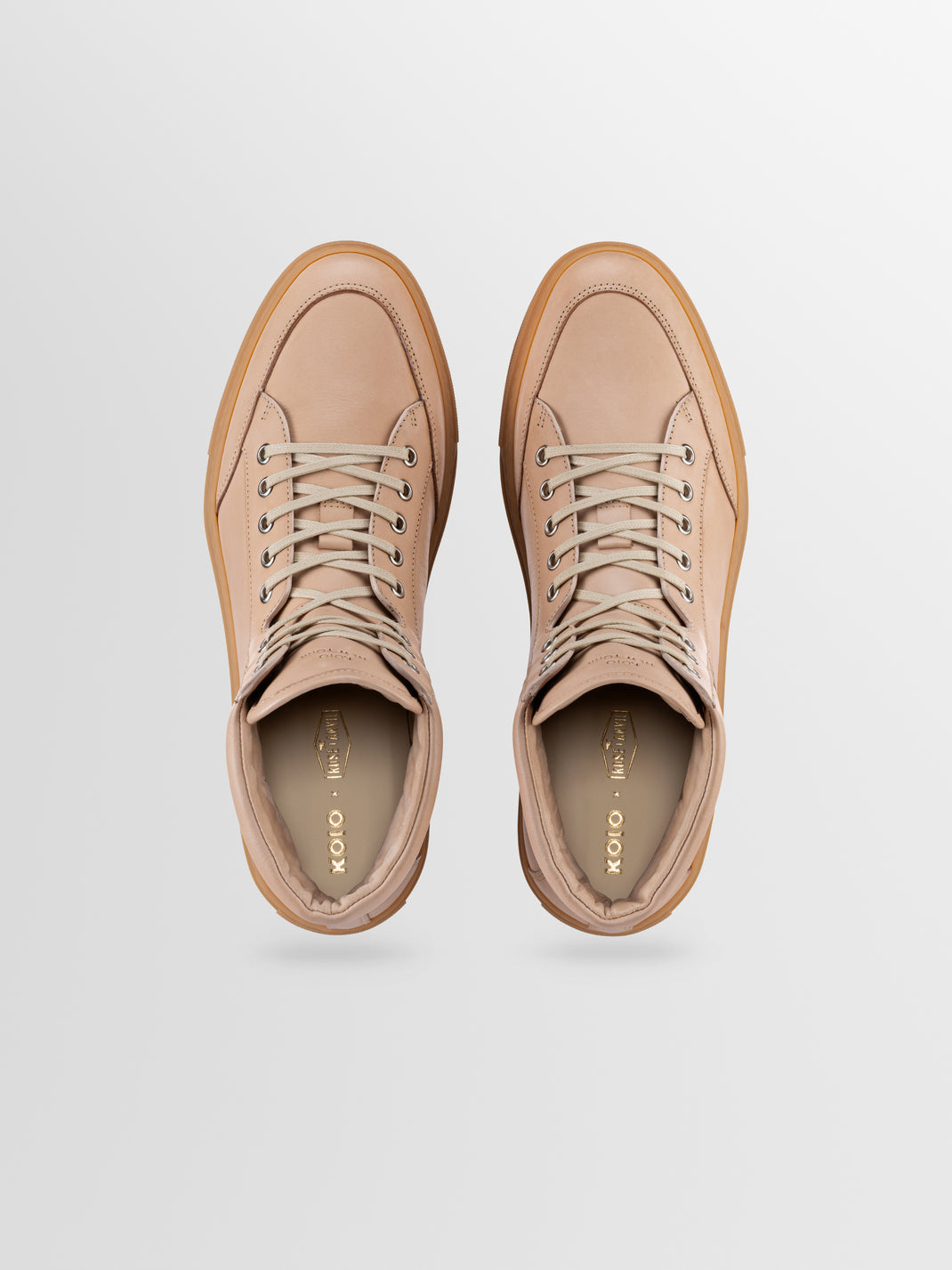 Top view of Primo Rose Anvil men’s beige leather high-top sneakers showcasing cream laces and rubber soles on a light gray background